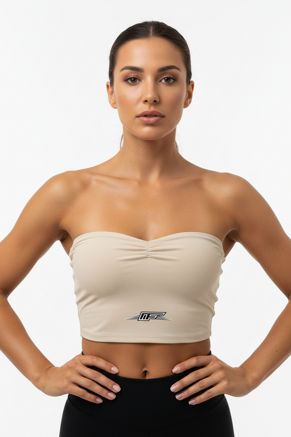 A beige strapless bandeau tube top with a gathered sweetheart neckline and a black and silver 'M-F' logo on the lower front, displayed on a solid white background.