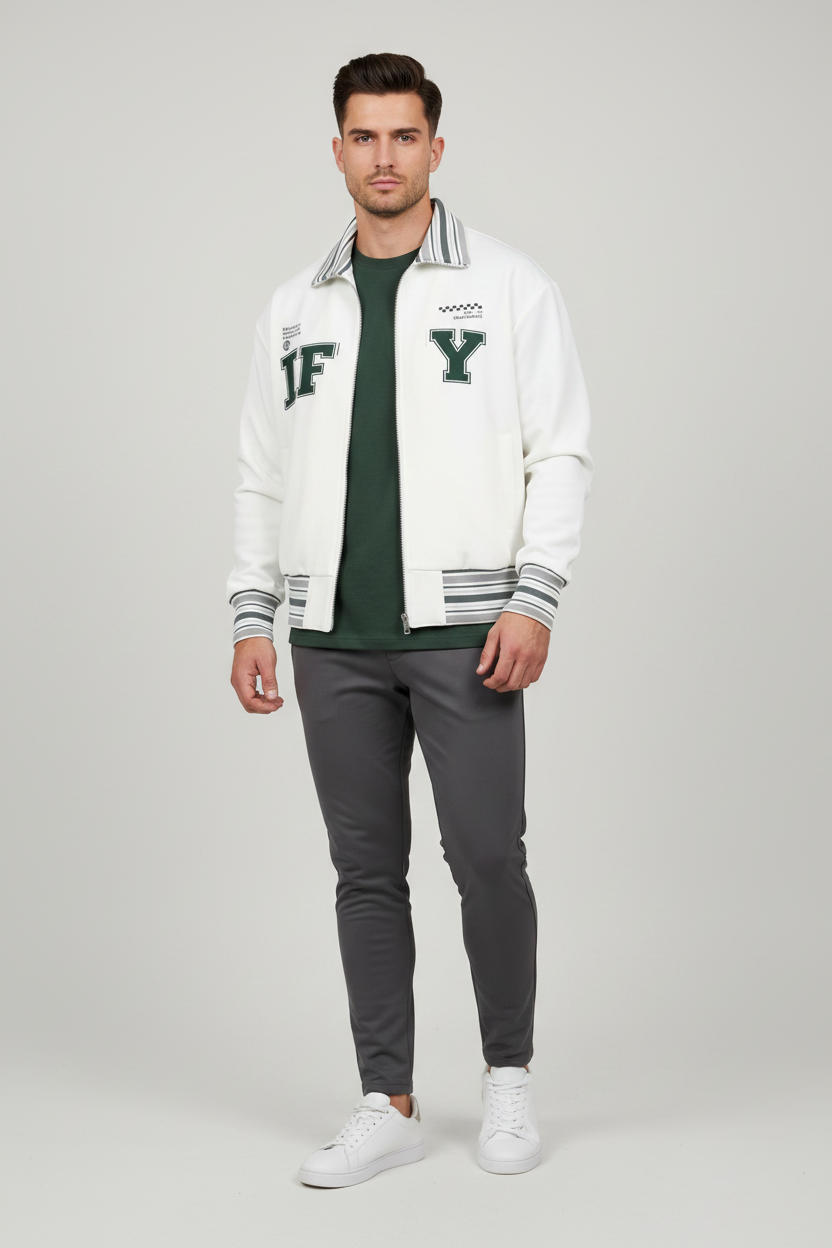 An off-white zip-up varsity jacket with green and gray striped ribbed collar, cuffs, and hem. The front features large collegiate-style letters 'IF' and 'Y' in dark green, with small graphic prints on the chest.