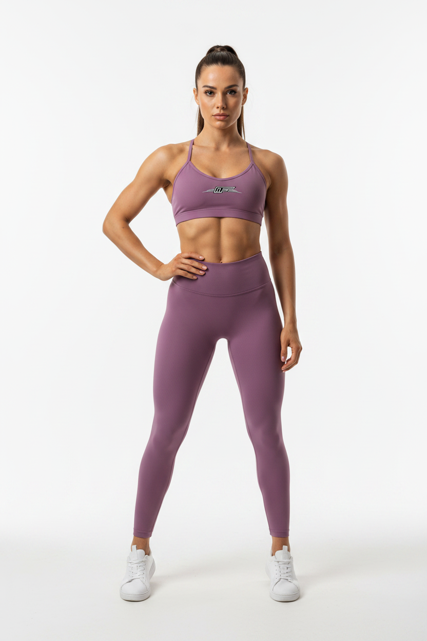 A dusty purple sports bra with a criss-cross racerback strap design and a black, white, and gray winged 'MF' logo on the center chest, displayed on a solid white background.