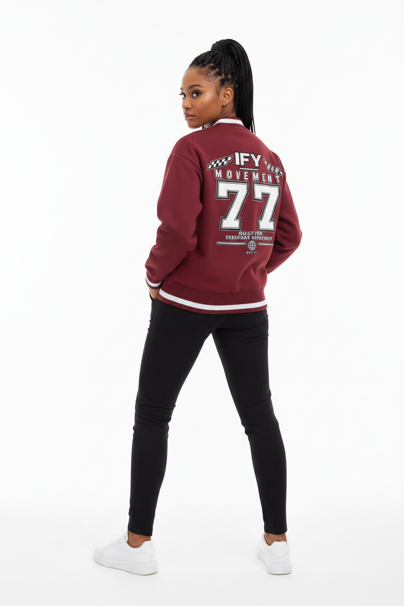 A maroon crewneck sweatshirt shown from the back, featuring a large graphic print with the text 'IFY MOVEMENT 77' and racing-themed checkered flags on a white background.