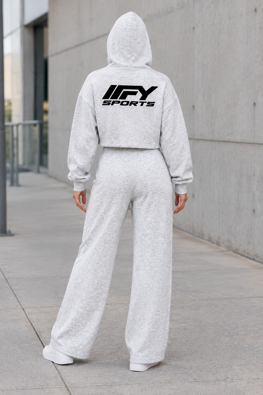 Female model back view wearing the light-grey IFY cropped hoodie and wide-leg sweatpants