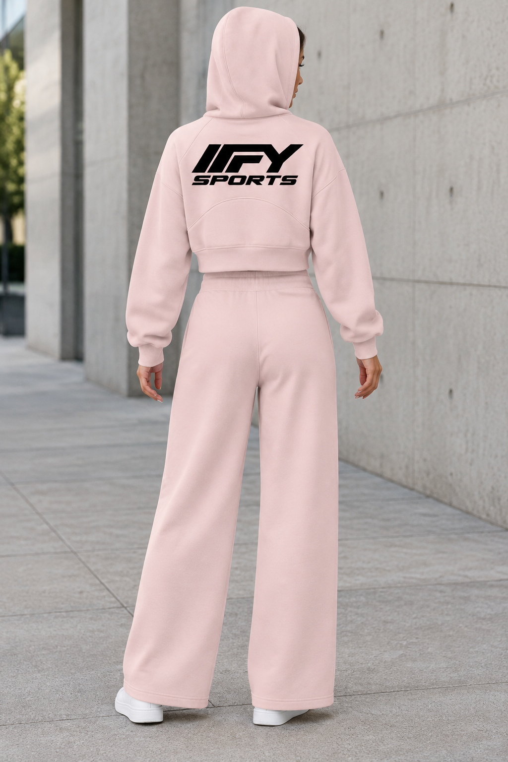 Female model back view wearing the pink IFY cropped hoodie and wide-leg sweatpants