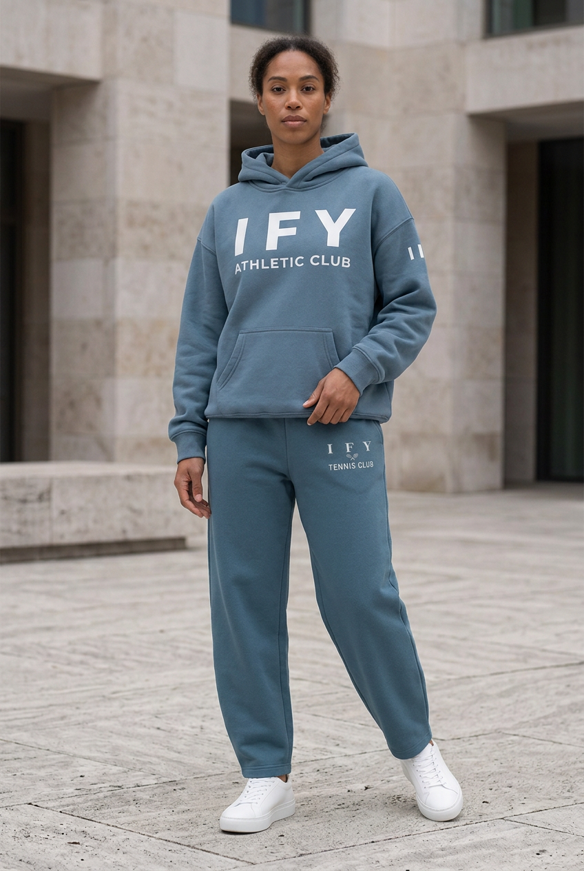 Female model in blue IFY hoodie and Haze Blue barrel-leg sweatpants