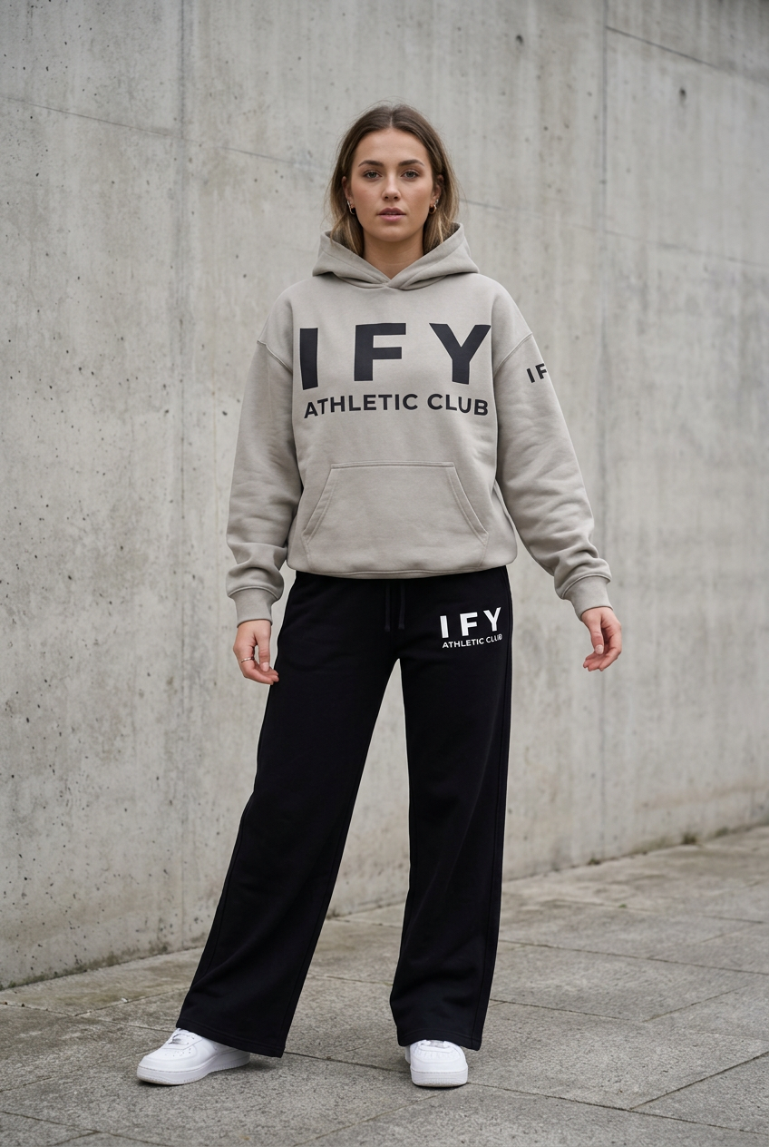 Female model in stone grey IFY hoodie and black sweatpants, front view