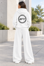 Female model showing the back of the white IFY outfit outdoors