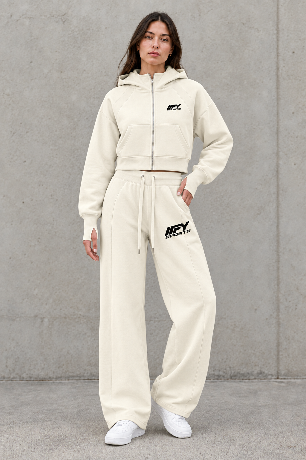 Female model wearing the cream IFY set in a relaxed streetwear pose