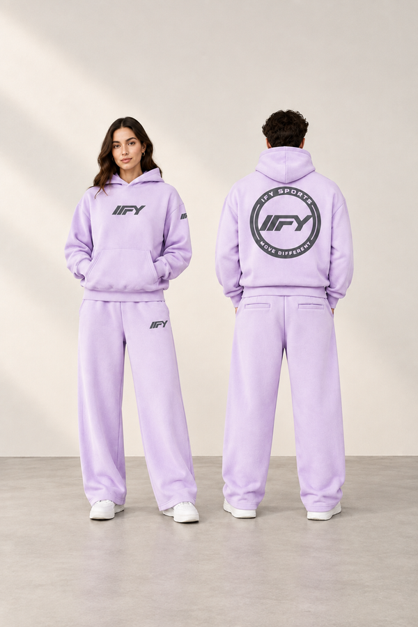Full-height portrait of a woman facing forward and a man showing the back of the lavender IFY set