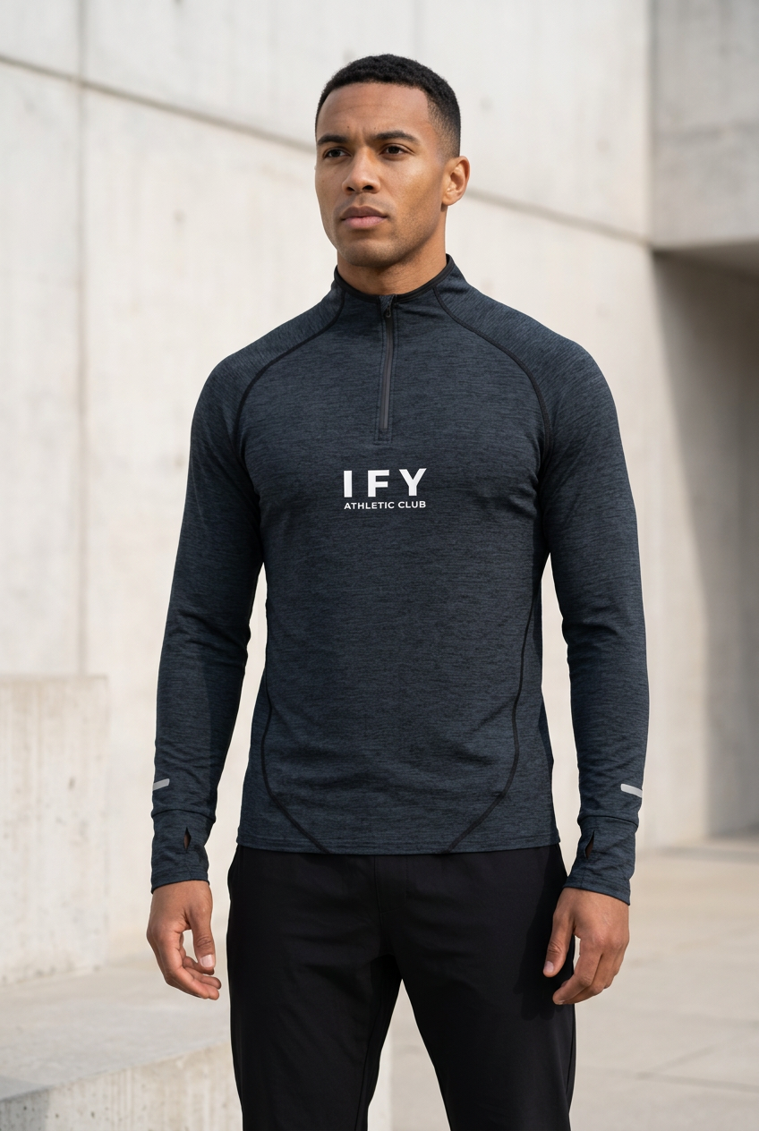 Male model wearing the IFY Static Blue long-sleeve quarter-zip raglan training top with black trousers