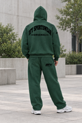 Male model back view in the green IFY outfit with hood up and rear trouser logo visible