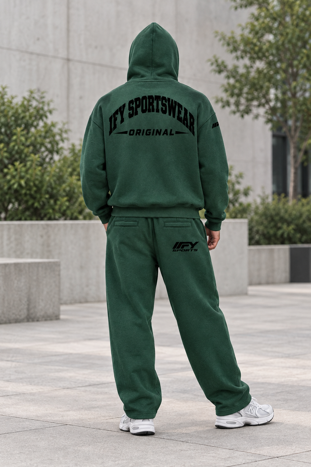 Male model back view in the green IFY outfit with hood up and rear trouser logo visible