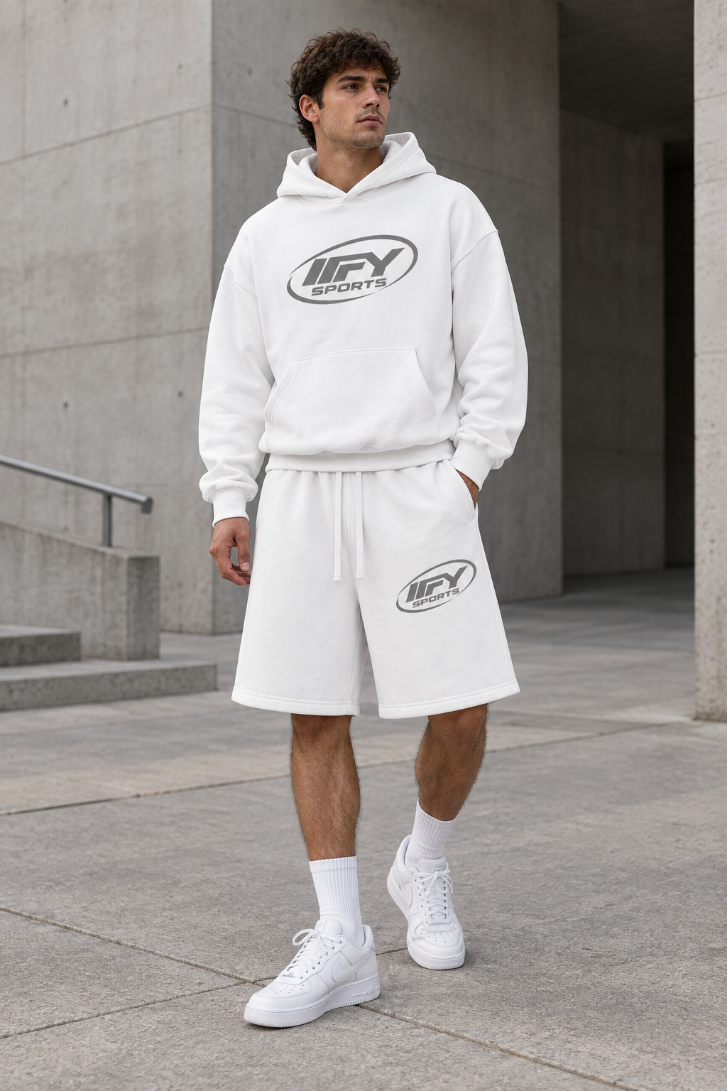 Male model front view wearing the white IFY hoodie and shorts with Nike trainers