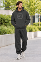 Male model in a charcoal IFY hoodie with relaxed sweatpants and chunky trainers