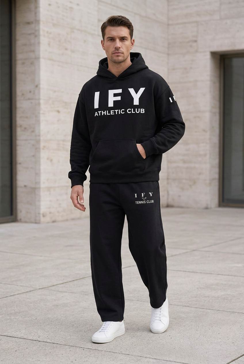 Male model in black IFY hoodie and black barrel-leg sweatpants