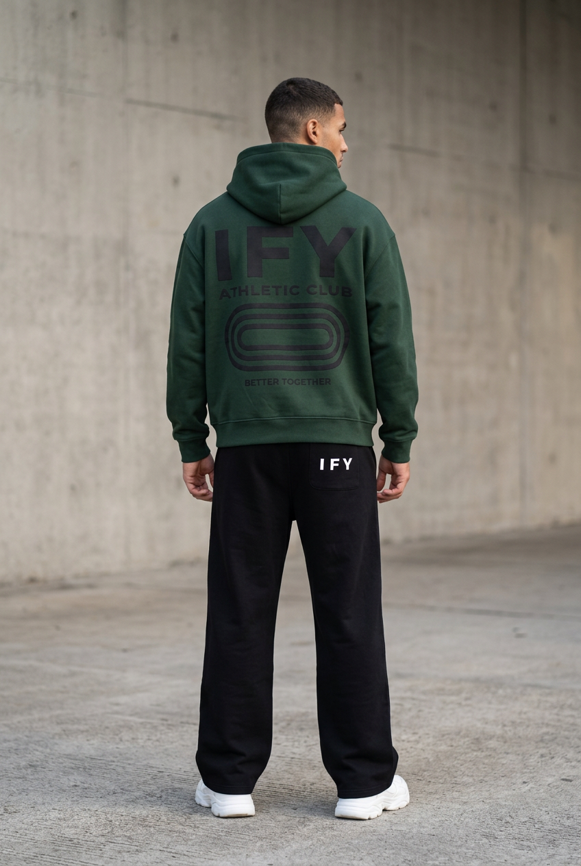 Male model in dark green IFY hoodie and black sweatpants, back view