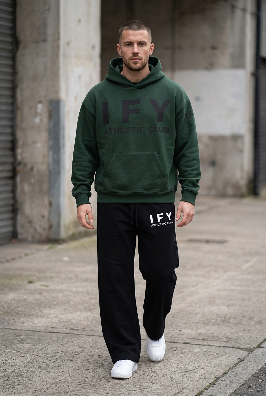 Male model in dark green IFY hoodie and black sweatpants, front view