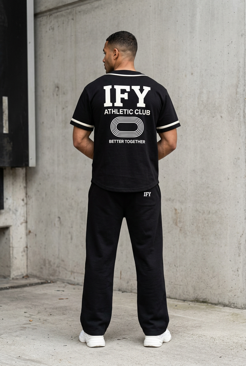 Male model wearing black IFY jersey and sweatpants, back view