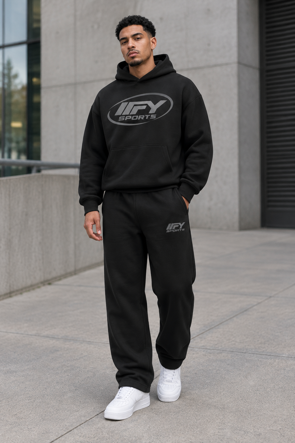 Male model wearing the black IFY hoodie and sweatpants set with white Nike Air Force 1 trainers