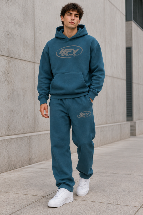Male model wearing the blue IFY hoodie and sweatpants set with white Air Force 1 trainers