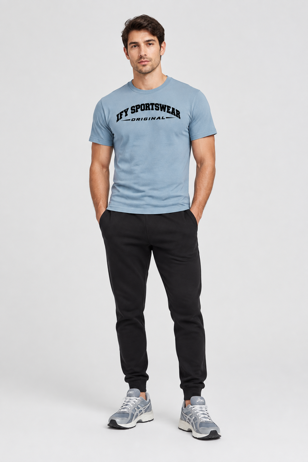 Male model wearing the blue IFY SPORTSWEAR ORIGINAL T-shirt with black joggers and ASICS trainers