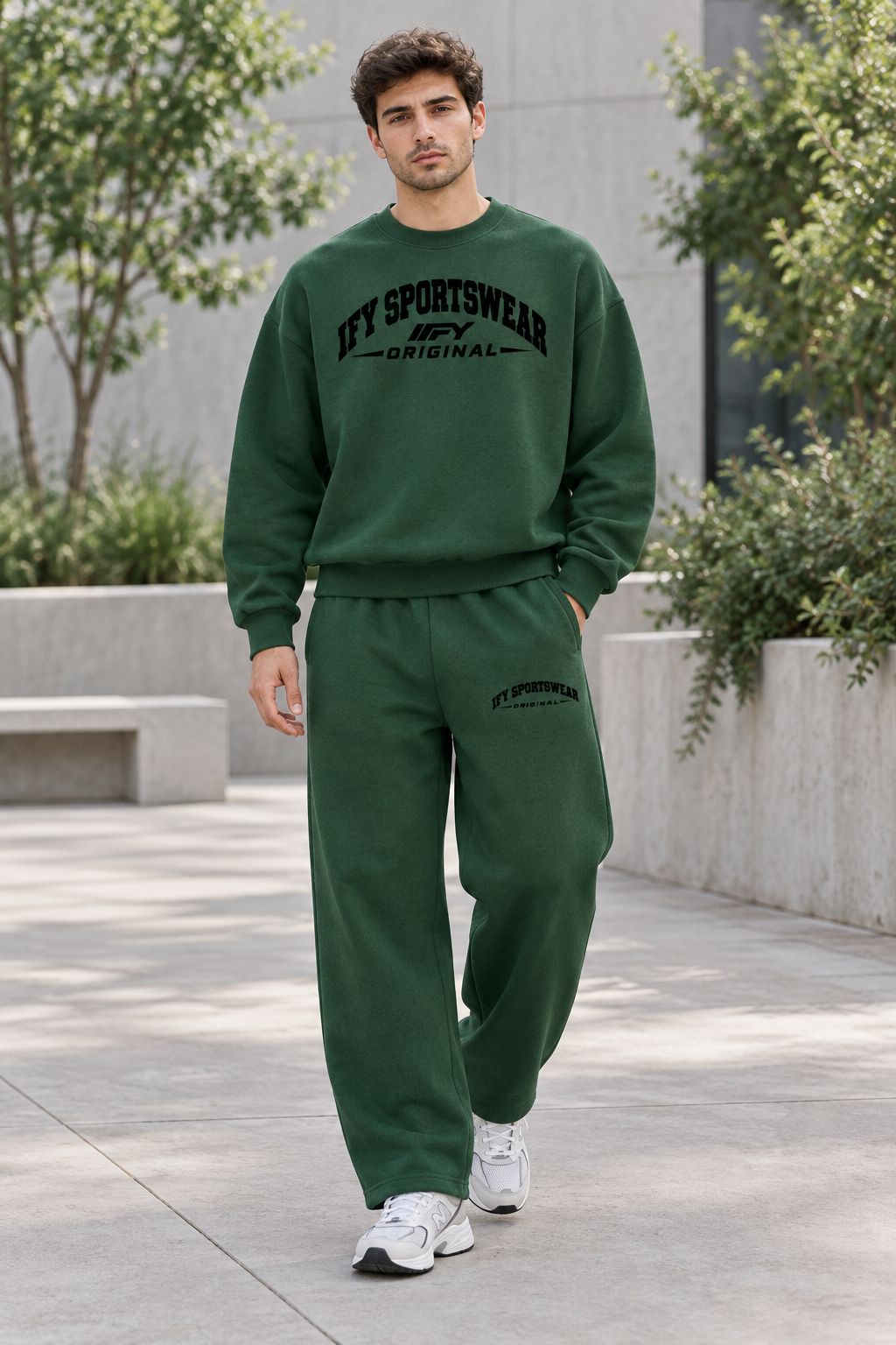 Male model wearing the forest-green IFY SPORTSWEAR ORIGINAL sweatshirt and barrel-leg sweatpants outdoors