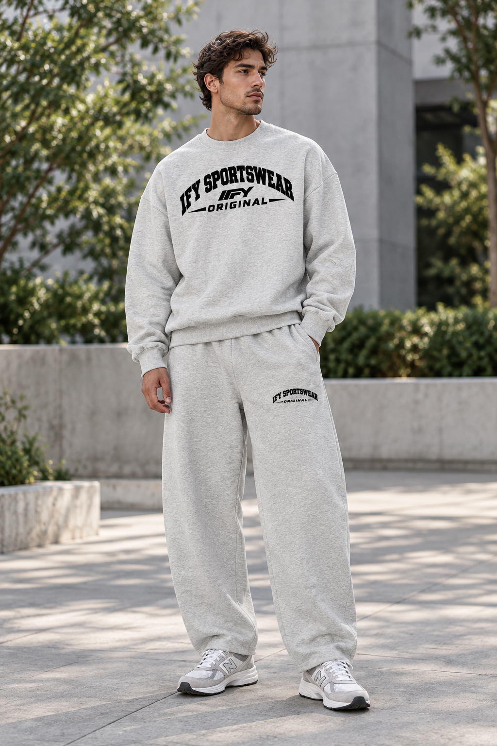 Male model wearing the grey IFY SPORTSWEAR ORIGINAL sweatshirt and barrel-leg sweatpants outdoors