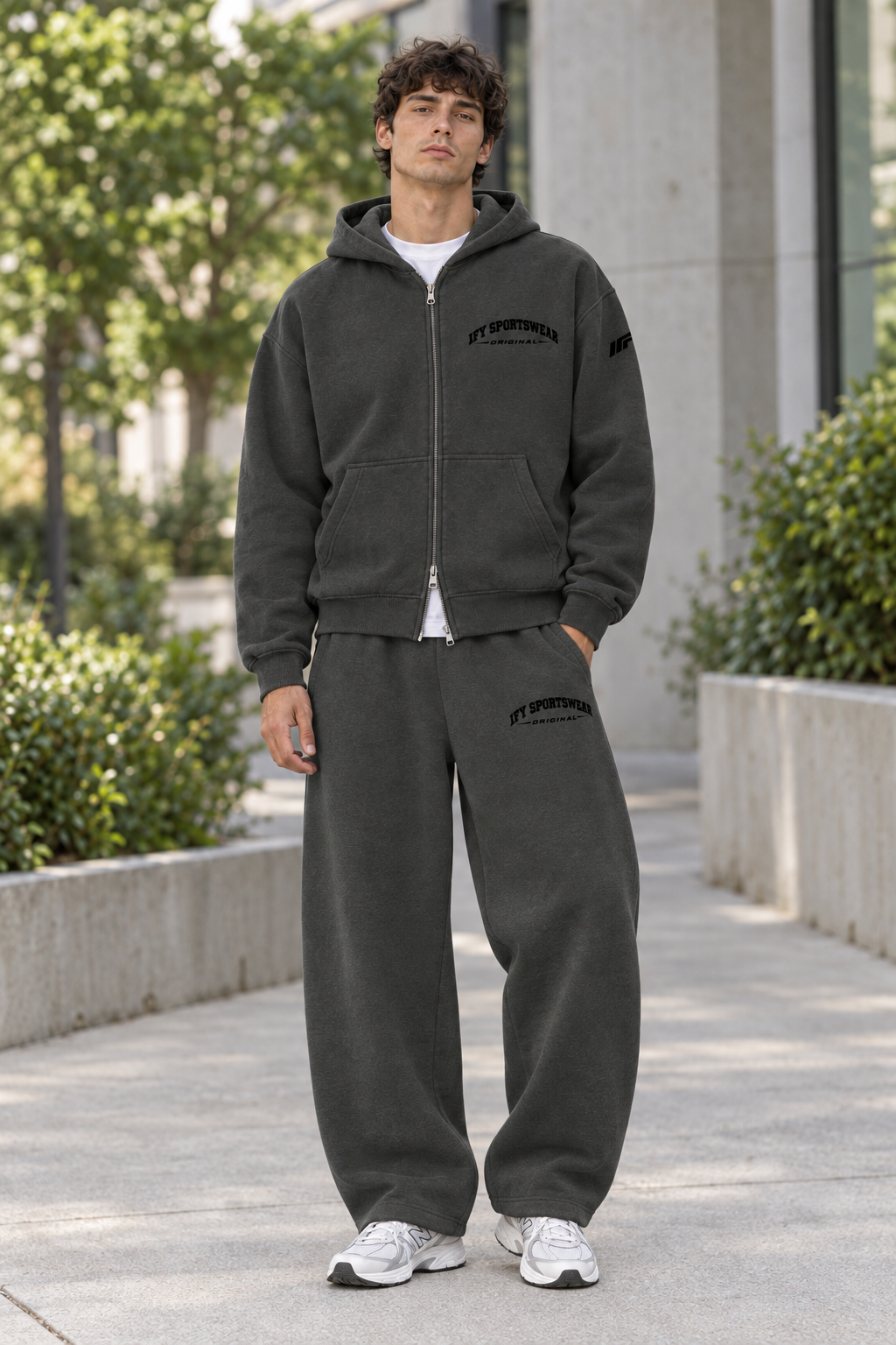 Male model wearing the matching charcoal IFY zip hoodie and barrel-leg sweatpants outdoors