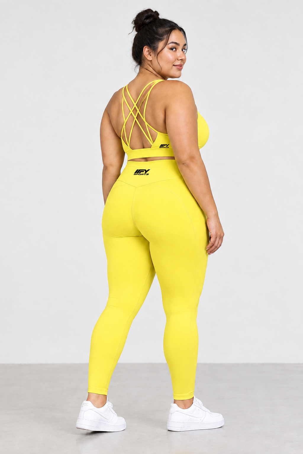 Plus-size model in the yellow outfit with the bra logo moved to the back right