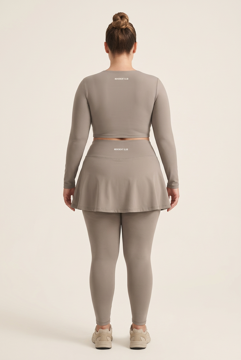 Plus-size model showing the back of the taupe Movement Club outfit