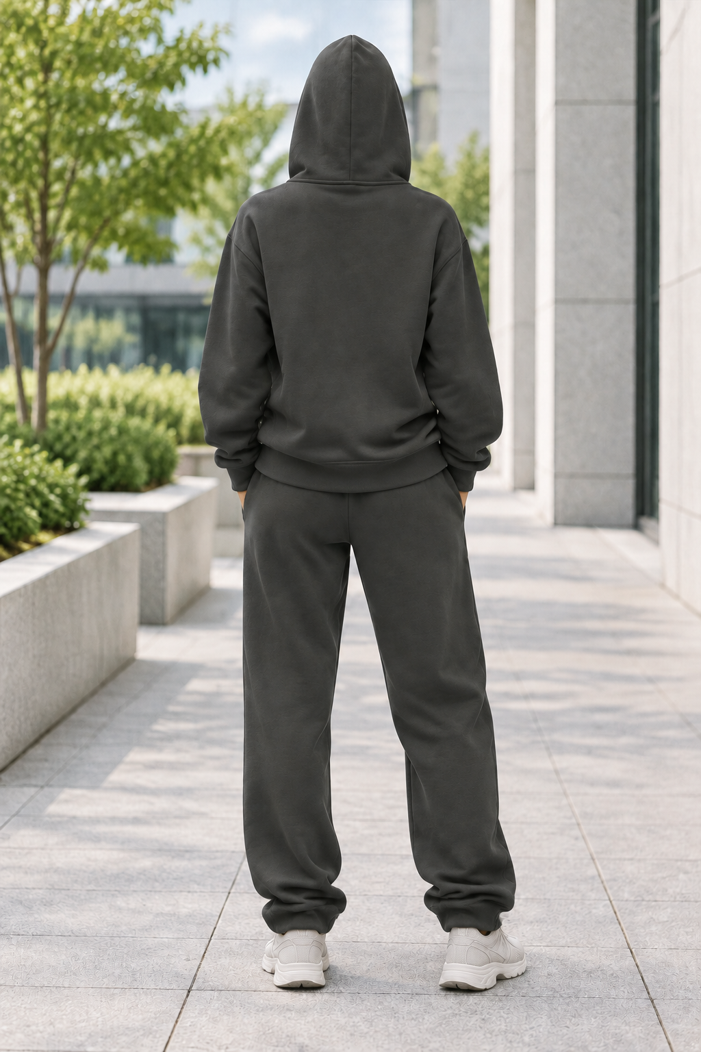 Streetwear-style rear view of a female model in a charcoal hoodie